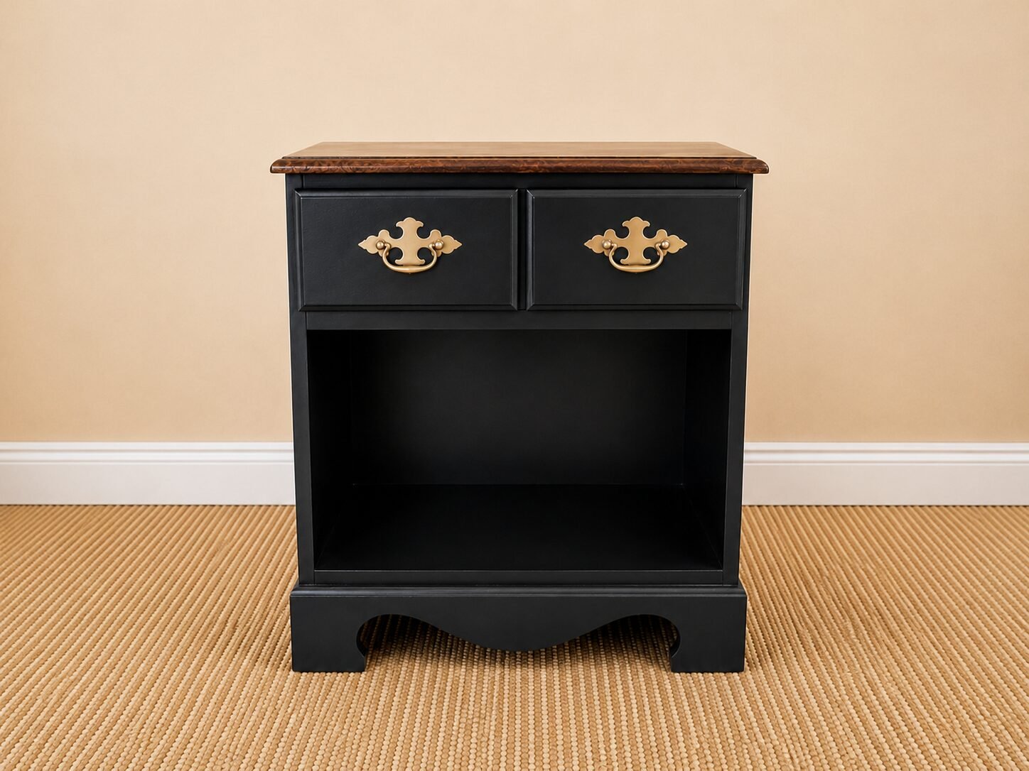Refinished black nightstand with brass hardware styled beside a green armchair in a cozy living room.