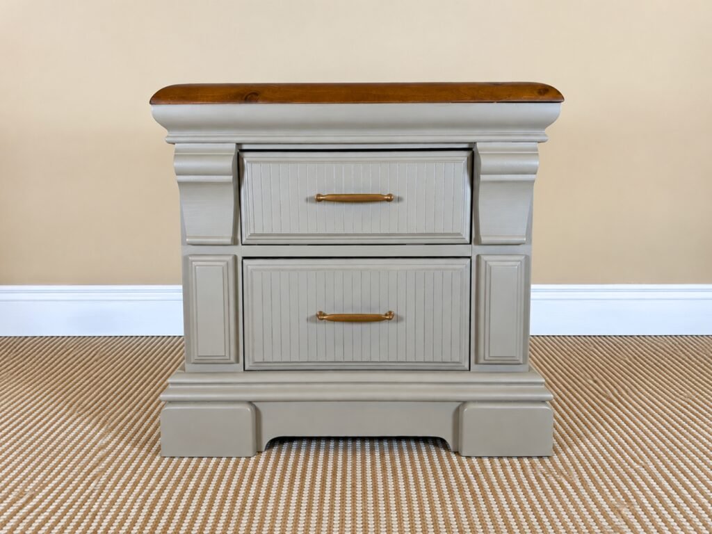 Sandstone two-drawer nightstand with stained wood top and antique brass hardware